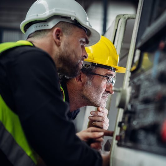 Mechanical Engineering Team Operating Machinery in a Manufacturing Workshop.
